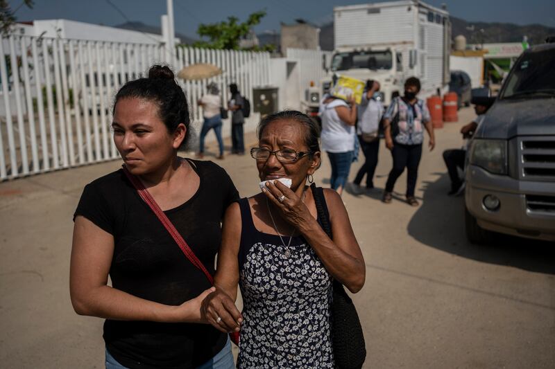 Relatives of Hurricane Otis victims seeking information outside a morgue in Acapulco. Photograph: Felix Marquez/AP