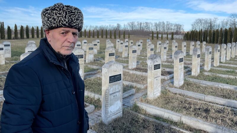 In Nazran, southern Russia, Ayub Tsurov stands before graves that await the remains of 192 Ingush people still missing, presumed dead, from a 1992 conflict between the neighbouring republics of North Ossetia and Ingushetia. Photograph: Daniel McLaughlin