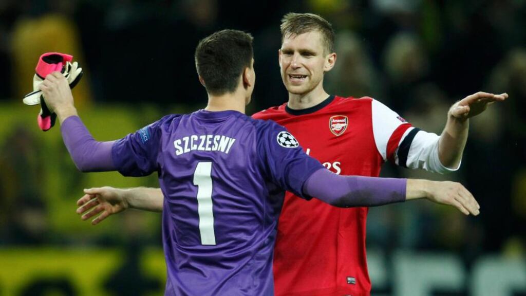 Arsenal’s goalkeeper Wojciech Szczesny and team-mate Per Mertesacker (right) celebrate after defeating Borussia Dortmund in their Champions League Group F match on Wednesday. Photograph: Ina Fassbender/Reuters