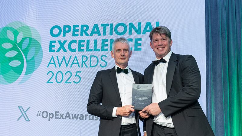 Seamus O'Reilly, awards judge, presents the operational excellence in financial & professional services award to Joe Shine, Quantmatix