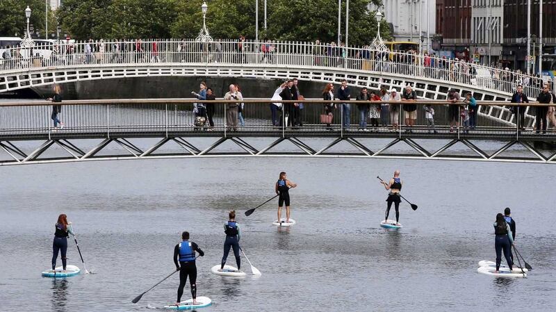 Stand-up paddle boarders on  the River Liffey in Dublin. Photograph: Sam Boal/Rollingnews.ie