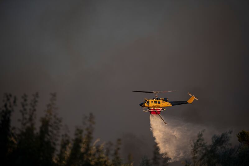 A helicopter drops water near Varnava village during a wildfire. Photograph: Michael Varaklas/AP