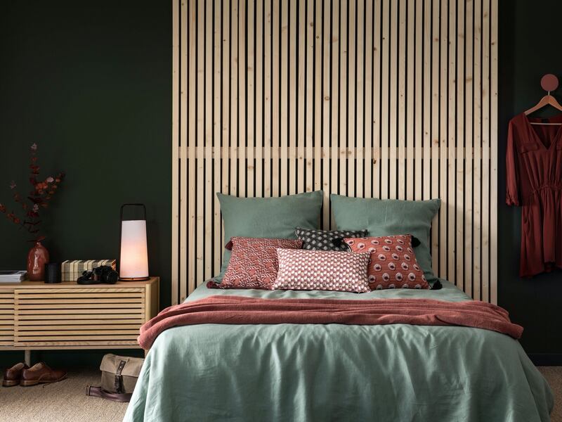Coloured bed linen in soft shades can be used to hide unsightly beds and create a sense of cohesion
