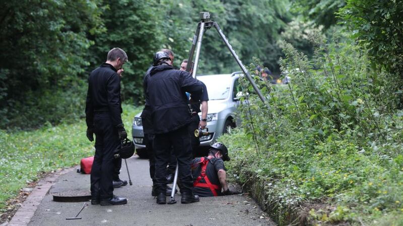 A member of the PSNI hazardous environment search team search a drain in Seaview Park during the search for missing Noah Donohoe who was last seen in the Shore Road area of north Belfast at the weekend. Photograph: Niall Carson/PA Wire