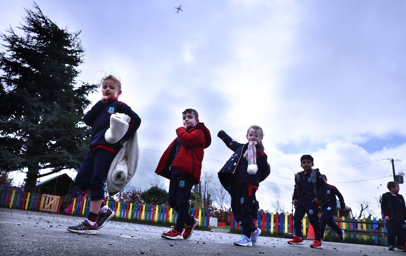 Children line up in the yard at Kilcoskan National School as an aircraft passes overhead. Photograph: Dara MacDónaill