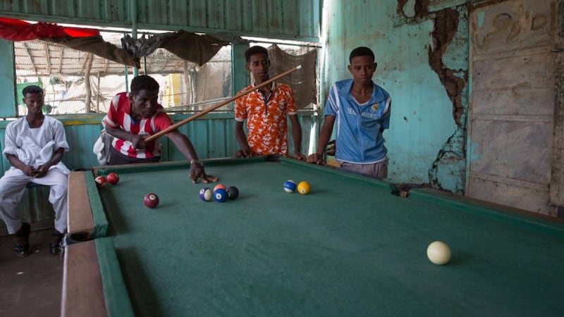 Eritrean refugees play pool in  Shagarab camp, eastern Sudan. Photograph: Sally Hayden