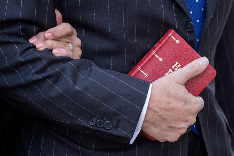 Roger Stone  holds a Bible while arriving for the second day of jury deliberations in his trial at DC Federal District Court in Washington on Friday. Photograph: Erik S Lesser/EPA