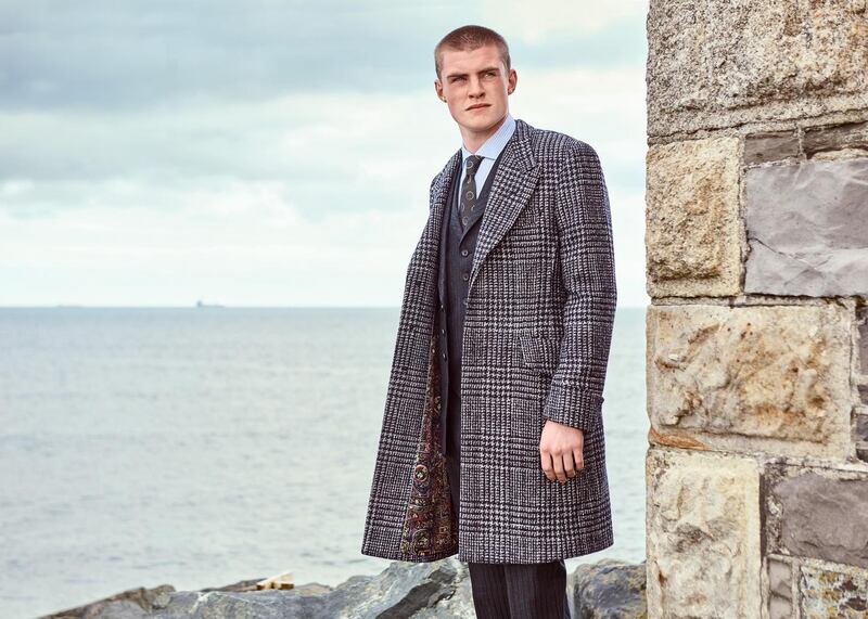 Fly fronted tweed coat with deep cuff and printed lining worn with a navy three piece suit. Paul Smith Collectiion. Photograph: James Mooney
