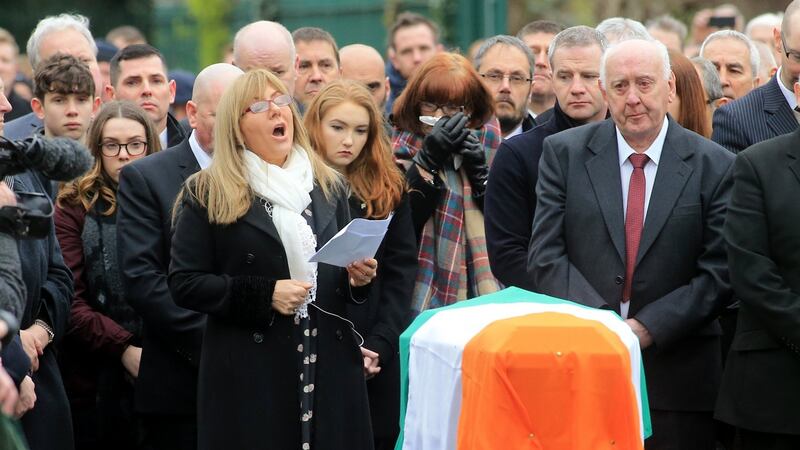 Frances Black sings beside the flag-draped coffin of Martin McGuinness outside St Columba’s Church. Photograph: Paul Mcerlane/EPA