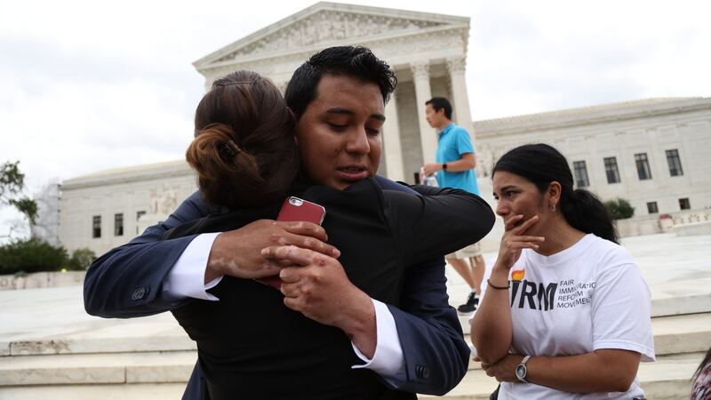 Immigration supporters react after the supreme court issued a split ruling on President Barack Obama’s immigration policy outside the Supreme Court in Washington. Photograph: Andrew Gombert/EPA