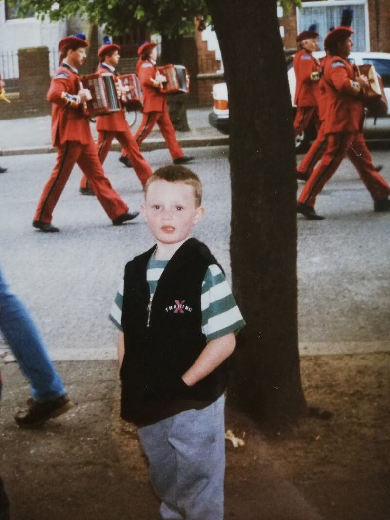 Scott McKendry attends a band parade as a child
