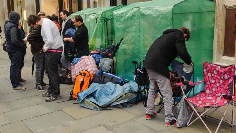 Customers camp outside the Apple store on Regent Street, London, as they await the launch of the latest Apple iPhone models. Photograph: Dominic Lipinski/PA Wire