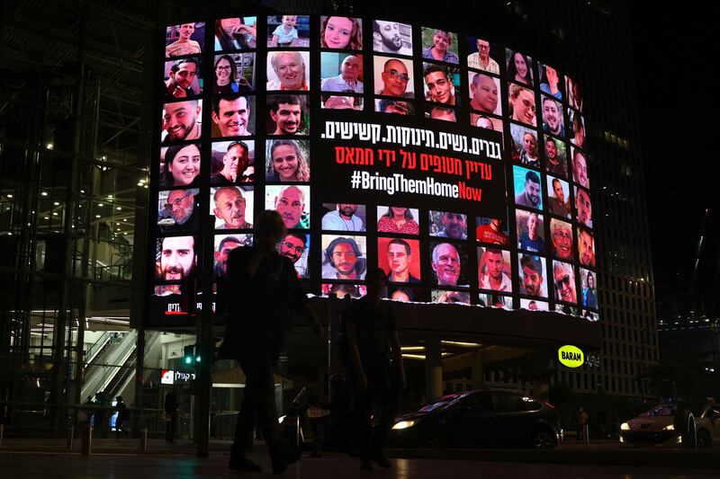 A billboard in Tel Aviv bearing portraits of Israeli hostages. Photograph: Ahmad Gharabli/AFP via Getty Images