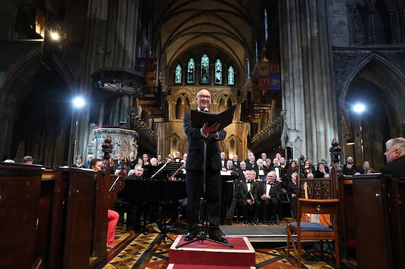 Chair of the Guinness Choir, John Healy, addresses the audience ahead of the choir's performance commemorating their 75th year