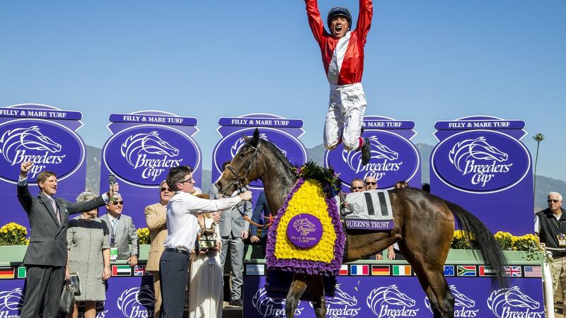 Lanfranco Dettori, leaps off of Queen’s Trust after winning the Breeders’ Cup Filly & Mare Turf in  2016  at Santa Anita Park  in Arcadia, California. Photograph:  Alex Evers/Breeders Cup via Getty