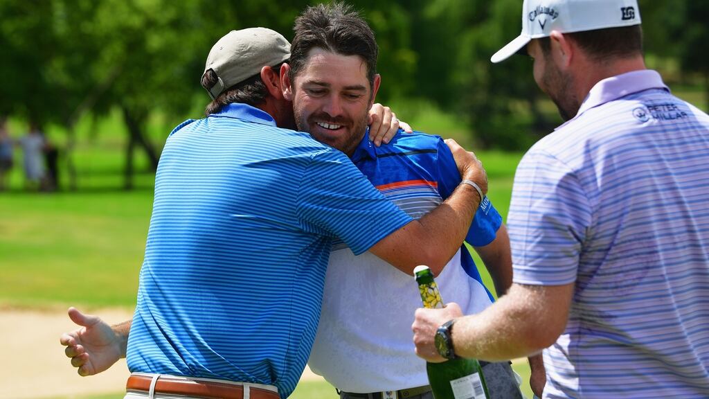 Louis Oosthuizen of South Africa (C) is congratulated by Thomas Aiken and Branden Grace after victory in the final round on day four of the South African Open at Randpark Golf Club in Johannesburg, South Africa. Photo: Stuart Franklin/Getty Images