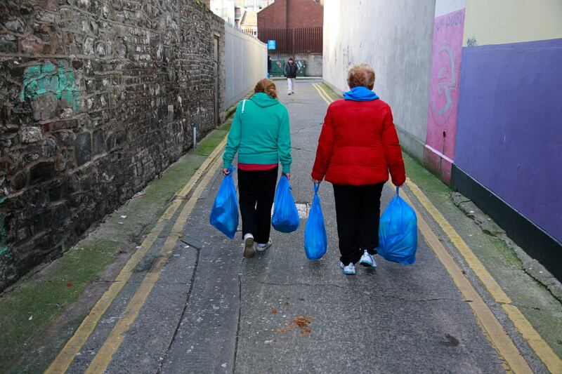 Each person queuing at the Capuchin Centre has a ticket entitling them to two blue plastic bags of food – one of non-perishables including tea, sugar, cereals, tinned fish, tinned beans, custard, chocolates and biscuits, and one of such perishables as milk, cheese, a chicken and butter. Photograph: Nick Bradshaw