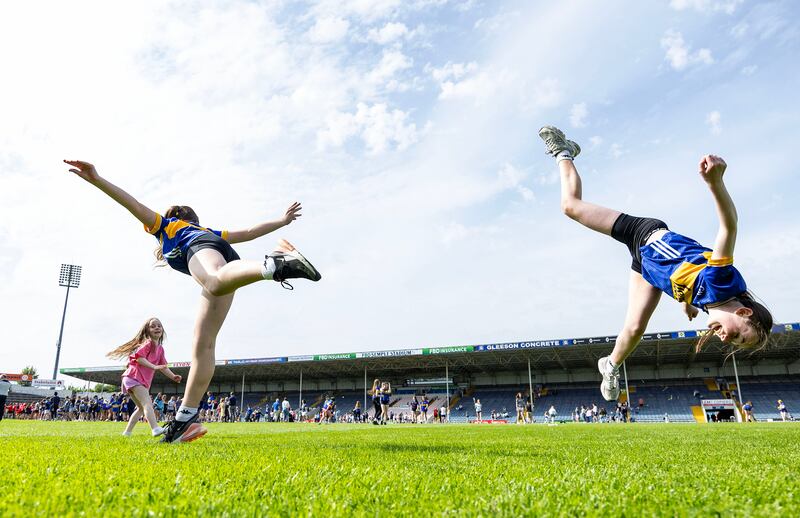 Young Tipperary fans Cara and Katie on the pitch after the match against Cork in Thurles. Photograph: Dan Clohessy/Inpho