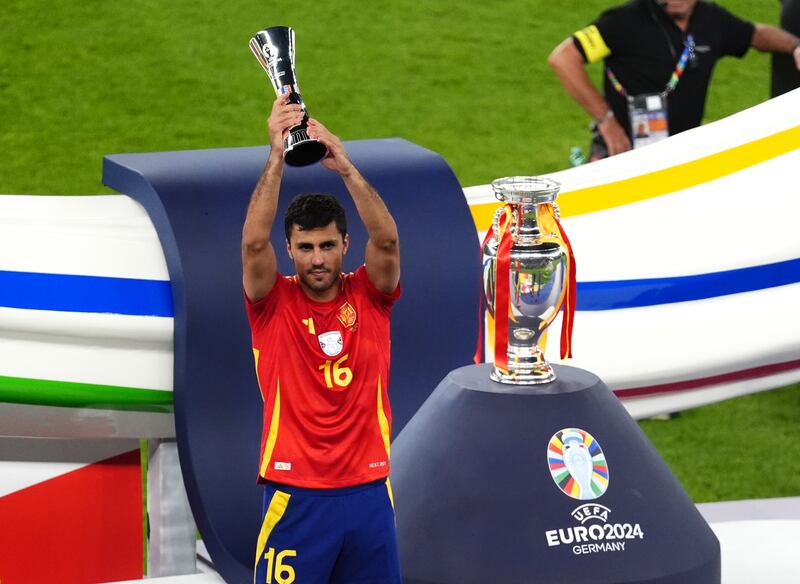 Spain's Rodri celebrates with a trophy following the UEFA Euro 2024 final match at the Olympiastadion, Berlin. Picture date: Sunday July 14, 2024. PA Photo. See PA Story SOCCER England. Photo credit should read: Andrew Milligan/PA Wire.

RESTRICTIONS: Use subject to restrictions. Editorial use only, no commercial use without prior consent from rights holder.