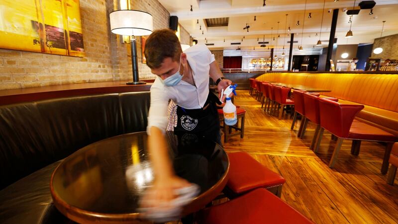 A staff member in  the Dakota bar in Dublin preparing for indoor dining. Photograph: Alan Betson