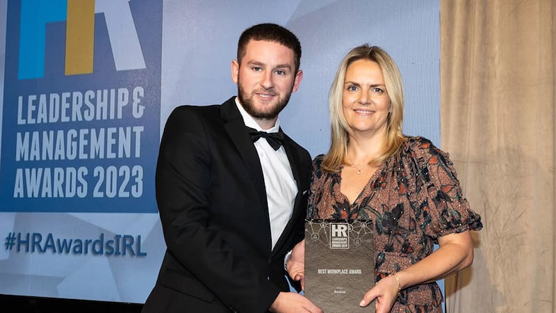 Adam Kane, entries lead, BusinessRiver, presents the best workplace award to Ciara Ruane, Avolon