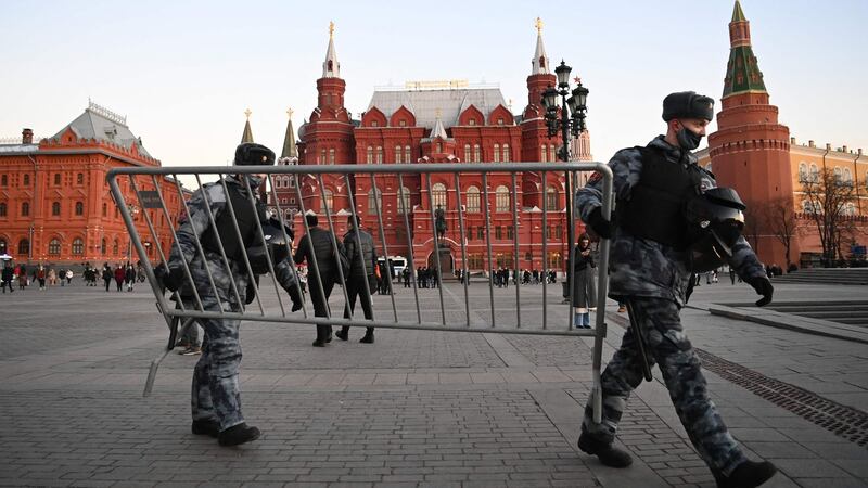Police officers put up metal barriers around central Moscow’s Manezhnaya Square on Wednesday. Photograph: Kirill Kudryavtsev/AFP