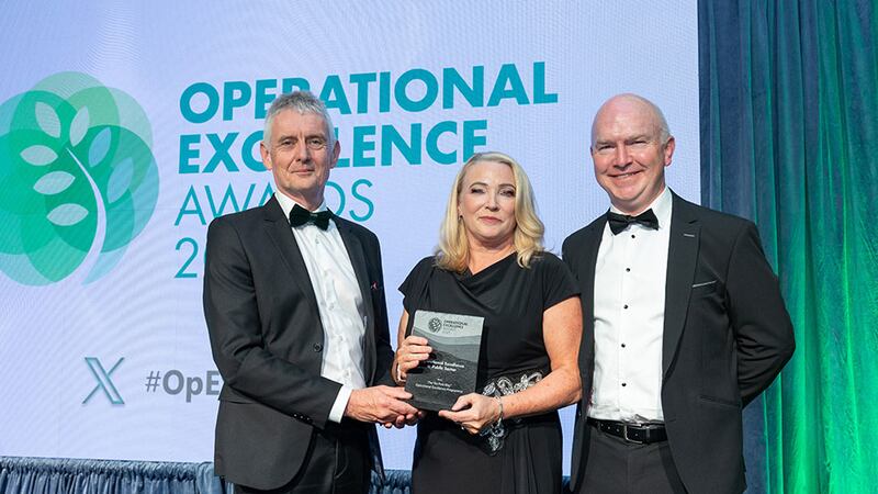 Seamus O'Reilly, awards judge, presents the operational excellence in public sector award to Ned Hayden and Teresa Kavanagh, An Post