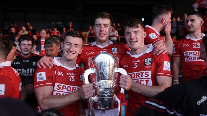 Cork's Patrick Horgan, Robert Downey and Eoin Downey celebrate with the Munster championship trophy. Photograph: Laszlo Geczo/Inpho