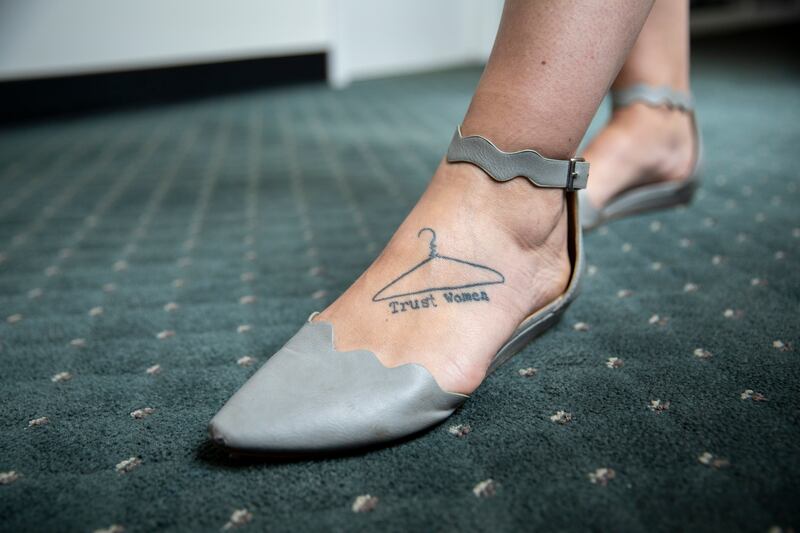 A tattoo on Bernard’s left foot shows a wire coat hanger — a symbol of a dangerous at-home abortions before the procedure was legal — over the words “Trust women”. Photograph: Amanda Andrade-Rhoades/New York Times