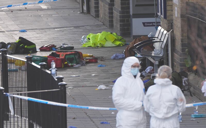 Forensic investigators at Huntingdon train station in England on Sunday. Photograph: Joe Giddens/PA Wire