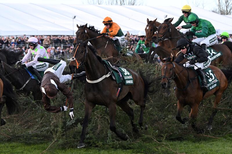 Harry Bannister falls from Domaine De L'Isle as they jump The Chair in the 2022 Grand National. Photograph: Paul Ellis/AF/Getty