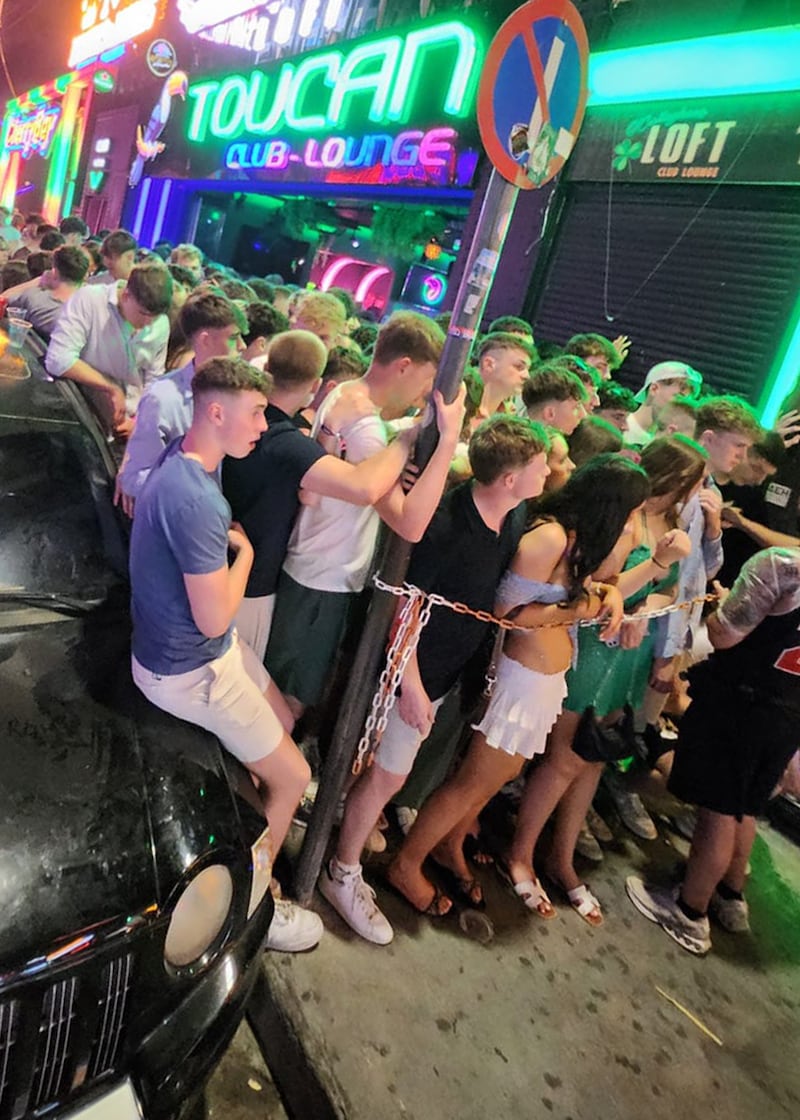Holidaymakers queue to enter The Loft, an Irish bar on the busy Laganas strip in Zakynthos. Photograph: Niamh Browne