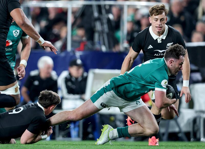 Ireland's Hugo Keenan is tackled by Cam Roigard of New Zealand. Photograph: Billy Stickland/Inpho