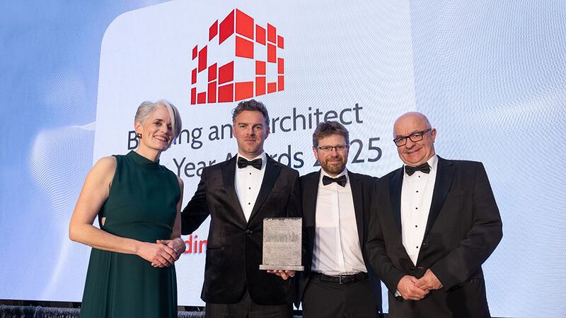 Emma Geoghegan, awards judge, presents the housing project of the year - large award to the Coady Architects team
