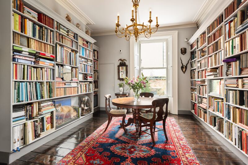 Dining room has walls of bookshelves