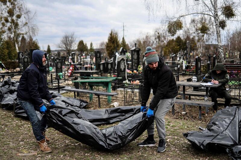 Workers line up bodies for identification by forensic personnel and police officers in the cemetery in Bucha, north of Kyiv, on April 6th after hundreds of civilians were found dead in areas from which Russian troops have withdrawn around Ukraine’s capital. Photograph: Ronaldo Schemidt/AFP via Getty