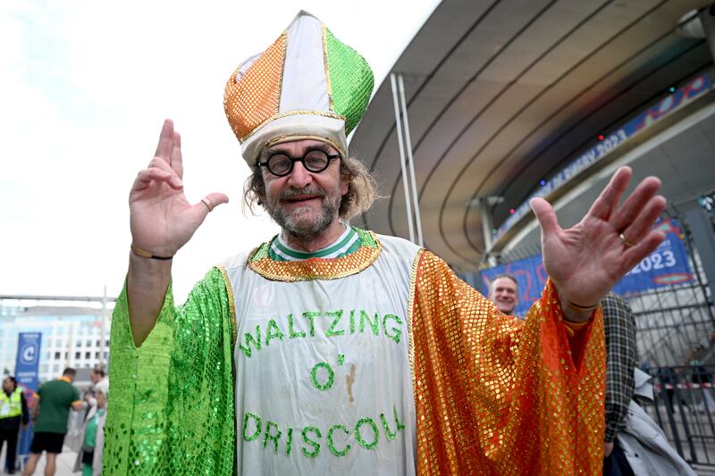 A man wearing a robe in the colour of the Irish flag which reads "Waltzing O'Driscoll". Photograph: Matthias Hangst/Getty