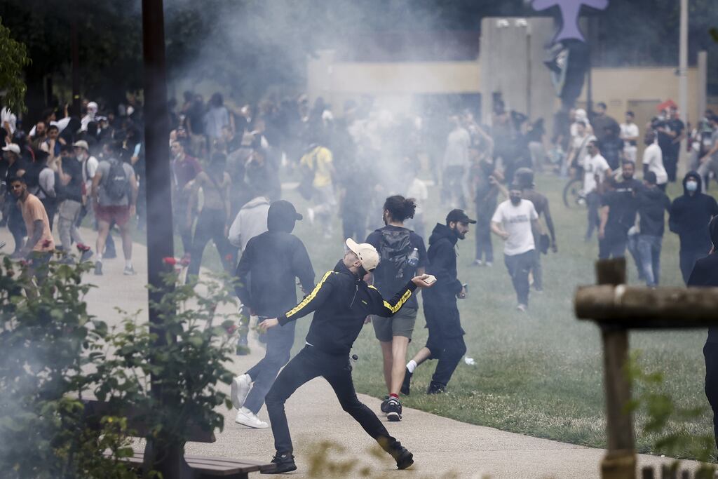 A protester throws a rock during clashes on Thursday with French riot police following a march in the memory of the 17-year-old, who was killed by French Police in Nanterre, near Paris (Photo: Shutterstock)