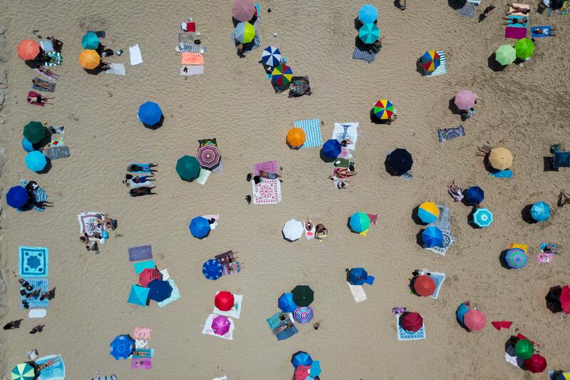 This aerial picture shows people sunbathing on Costa da Caparica beach in Almada, near Lisbon on Sunday. Photograph: Carlos Costa/AFP/Getty