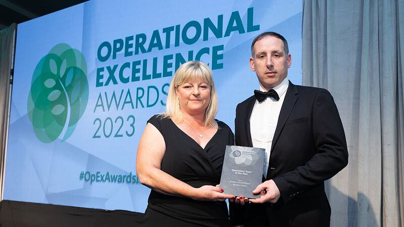 Sonia Fallon, bid manager and ESG lead at Sensori Facilities Management, presents the operations team of the year award to Garrett Ghee, Breedon Group