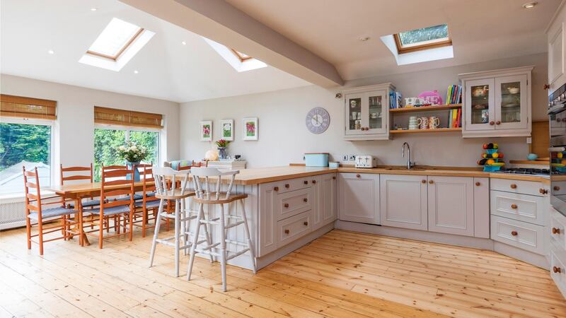 The kitchen at 18 Springfield Road has been extended to create a large, open-plan space with glazing on three sides and more glazing in the roof.