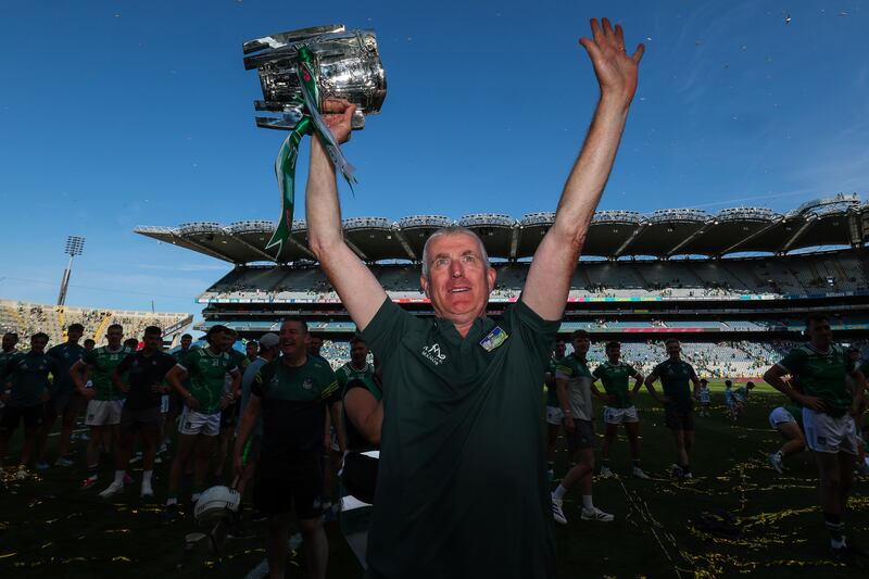 Limerick manager John Kiely lifts the Liam MacCarthy trophy after the match. Photograph: Ryan Byrne/Inpho