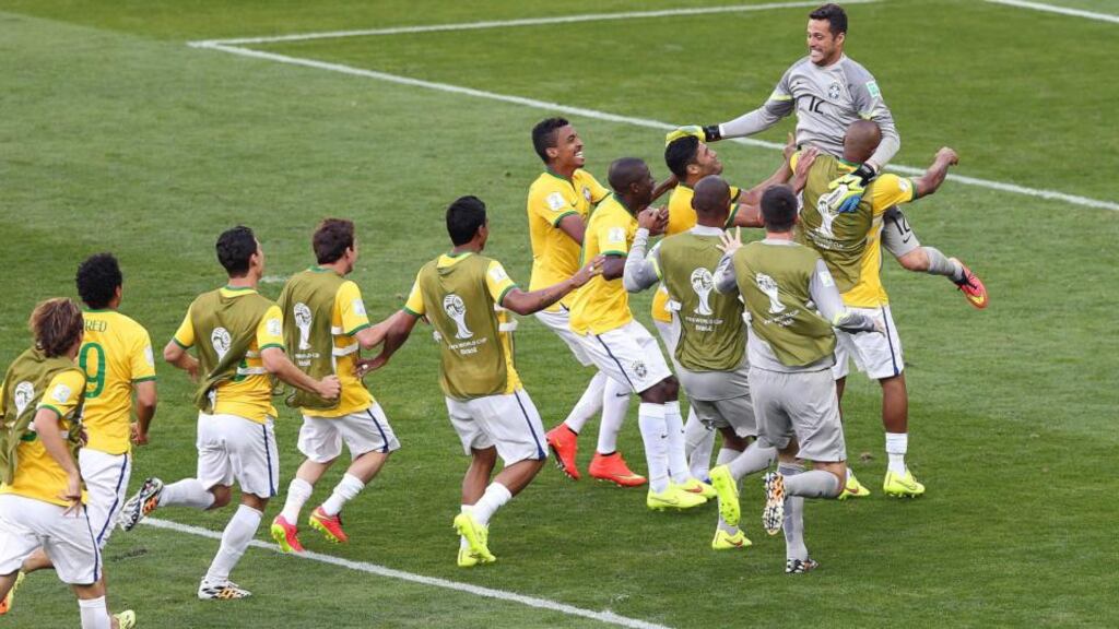 Brazil’s players celebrate after winning the penalty shoot against Chile at the Mineirao Stadium in Belo Horizonte. Photograph: EPA
