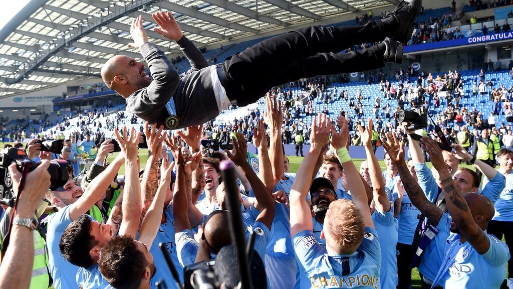 Manchester City players throw manager Josep Guardiola in the air as they celebrate winning the Premier League title. Photograph: Mike Hewitt/Getty
