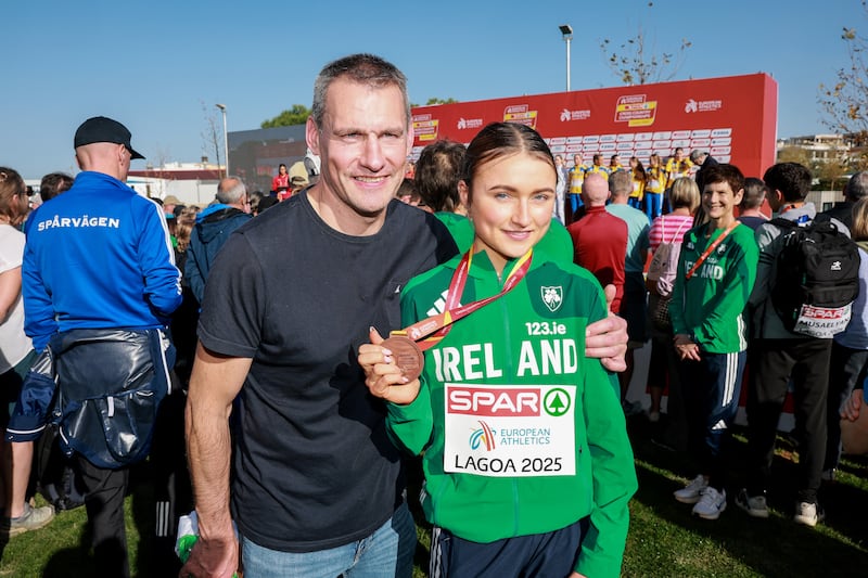 Ireland’s Emma Hickey with her father John after her third-place finish in the women's under-20 race. Photograph: Morgan Treacy/Inpho
