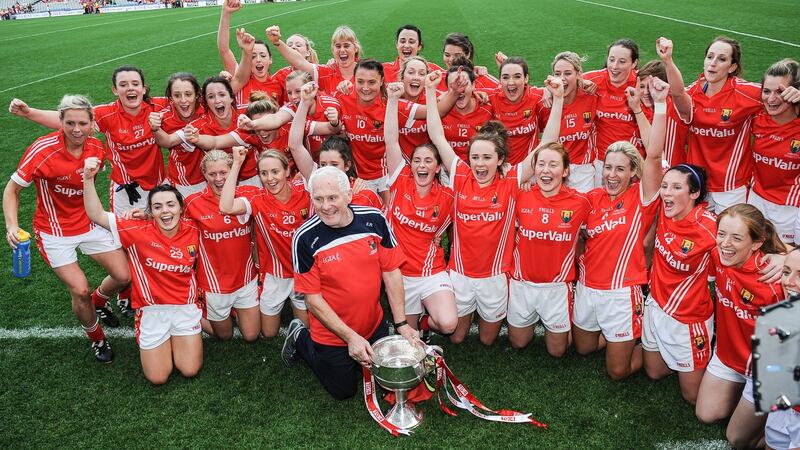 The Cork team and Eamonn Ryan celebrate their 2014 All-Ireland victory. Photograph: Tommy Grealy/Inpho