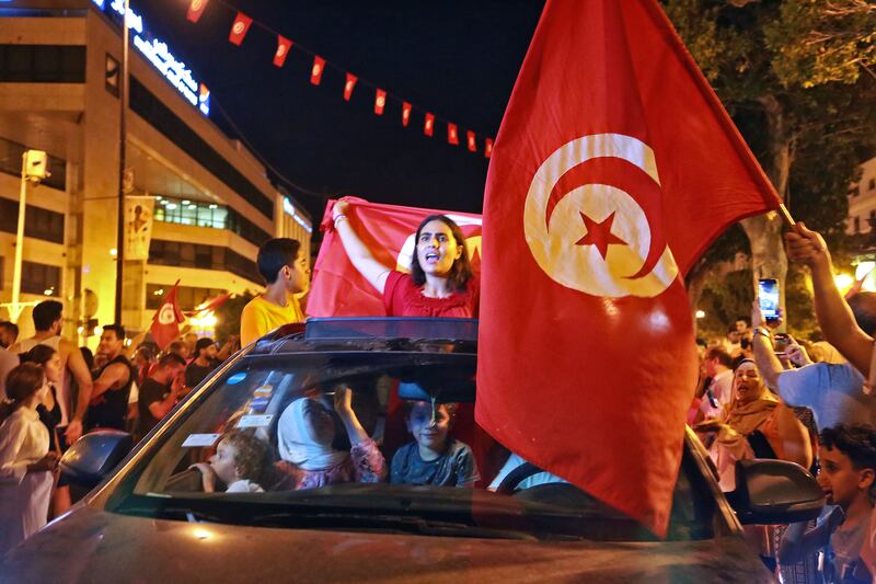 Supporters of president Kais Saied rejoice on Habib Bourguiba Avenue in the capital Tunis after the projected outcome was announced. Photograph: Anis Mili/AFP via Getty Images