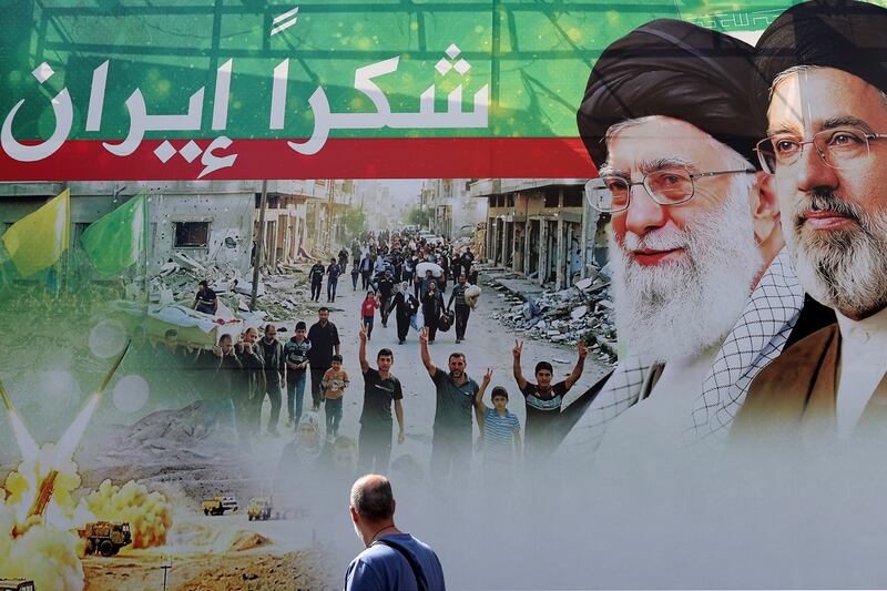 A man walks past a giant billboard depicting the late Iranian leader Ayatollah Ali Khamenei (second from left) and his son, the current Iranian supreme leader Ayatollah Mojtaba Khamenei, with Arabic writing that reading 'thank you Iran', in Beirut's southern suburbs on Monday. Photograph: Anwar Amro/AFP via Getty