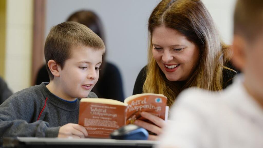 Roisin Ingle reading with Adam Duffy, 4th class student at St. Josephs Co-Ed School East Wall, volunteering with Suas Literacy Programme as part of National Giving Week. Photograph: Alan Betson / THE IRISH TIMES