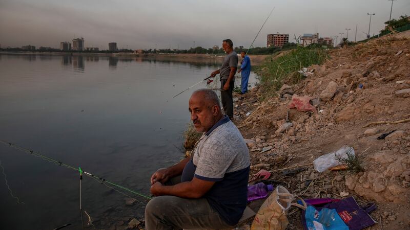 Fishing on the banks of the Tigris river in Baghdad. Iraqis vote on Sunday in parliamentary elections called a year early, after huge anti-government protests. Photograph: Andrea DiCenzo/New York Times